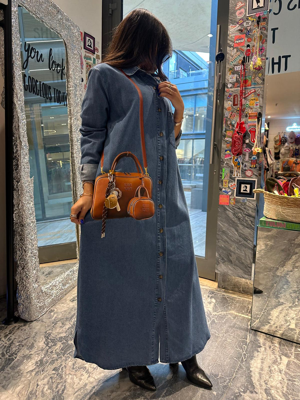 Brown bag on long denim dress