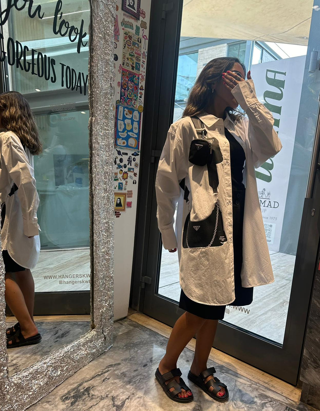 White shirt with black hanging mini bag