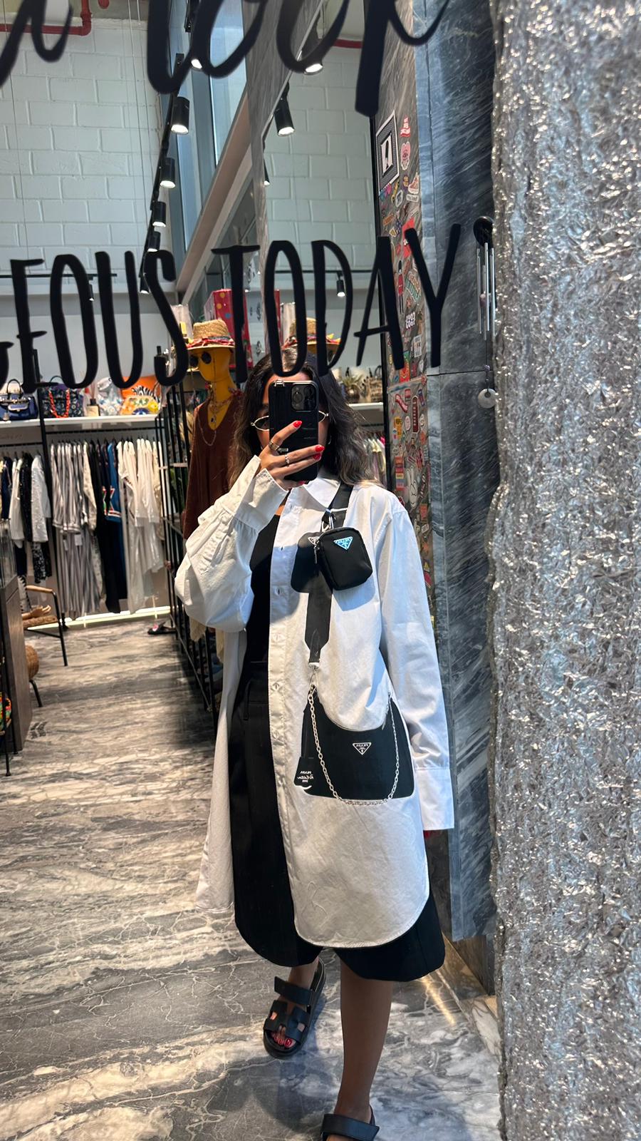 White shirt with black hanging mini bag