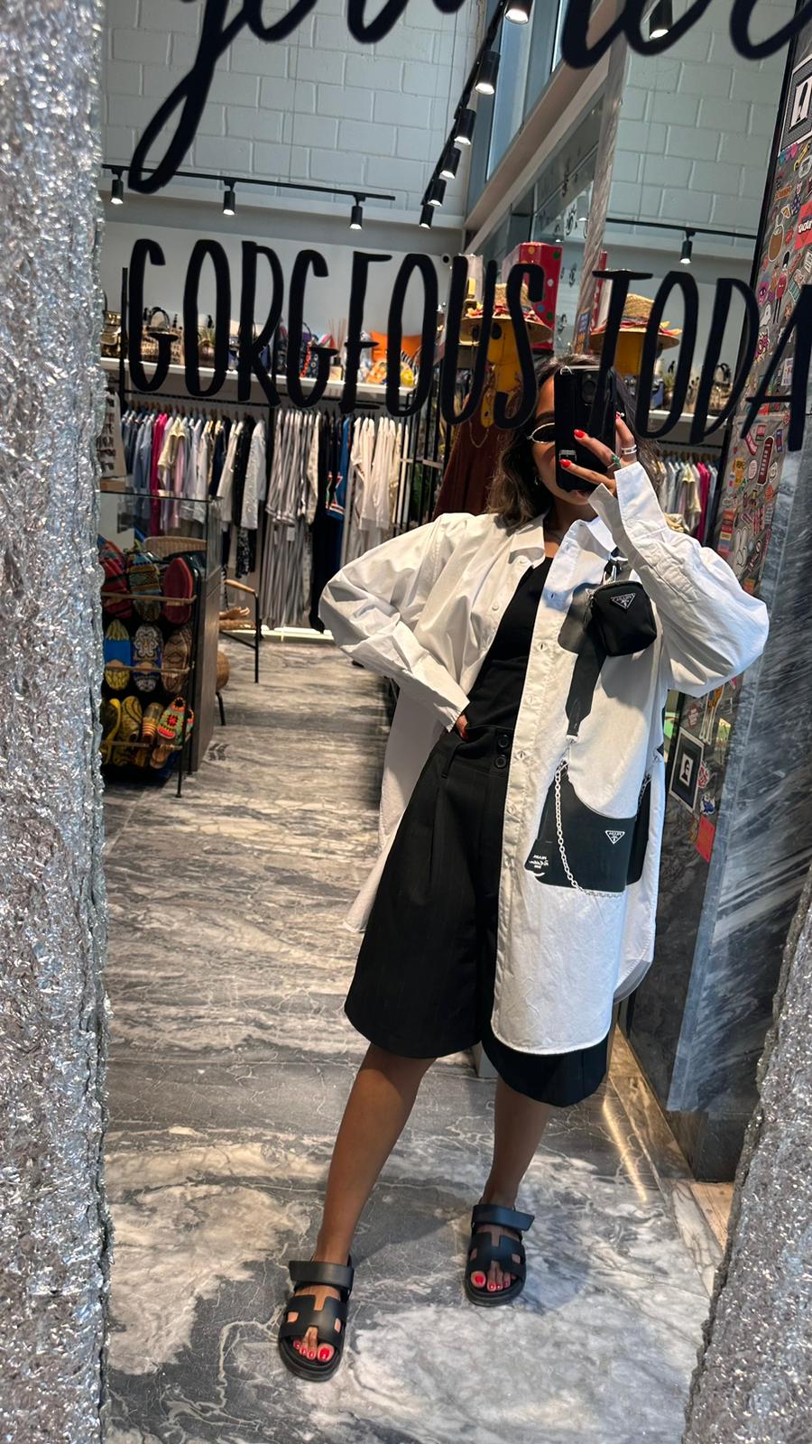 White shirt with black hanging mini bag