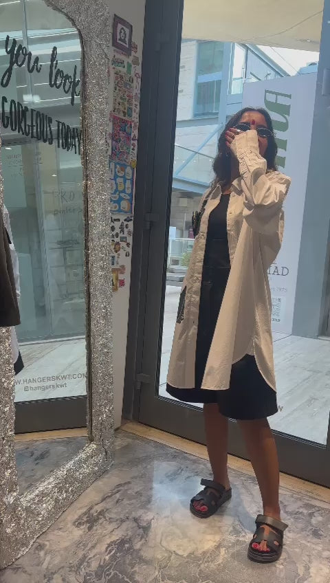 White shirt with black hanging mini bag